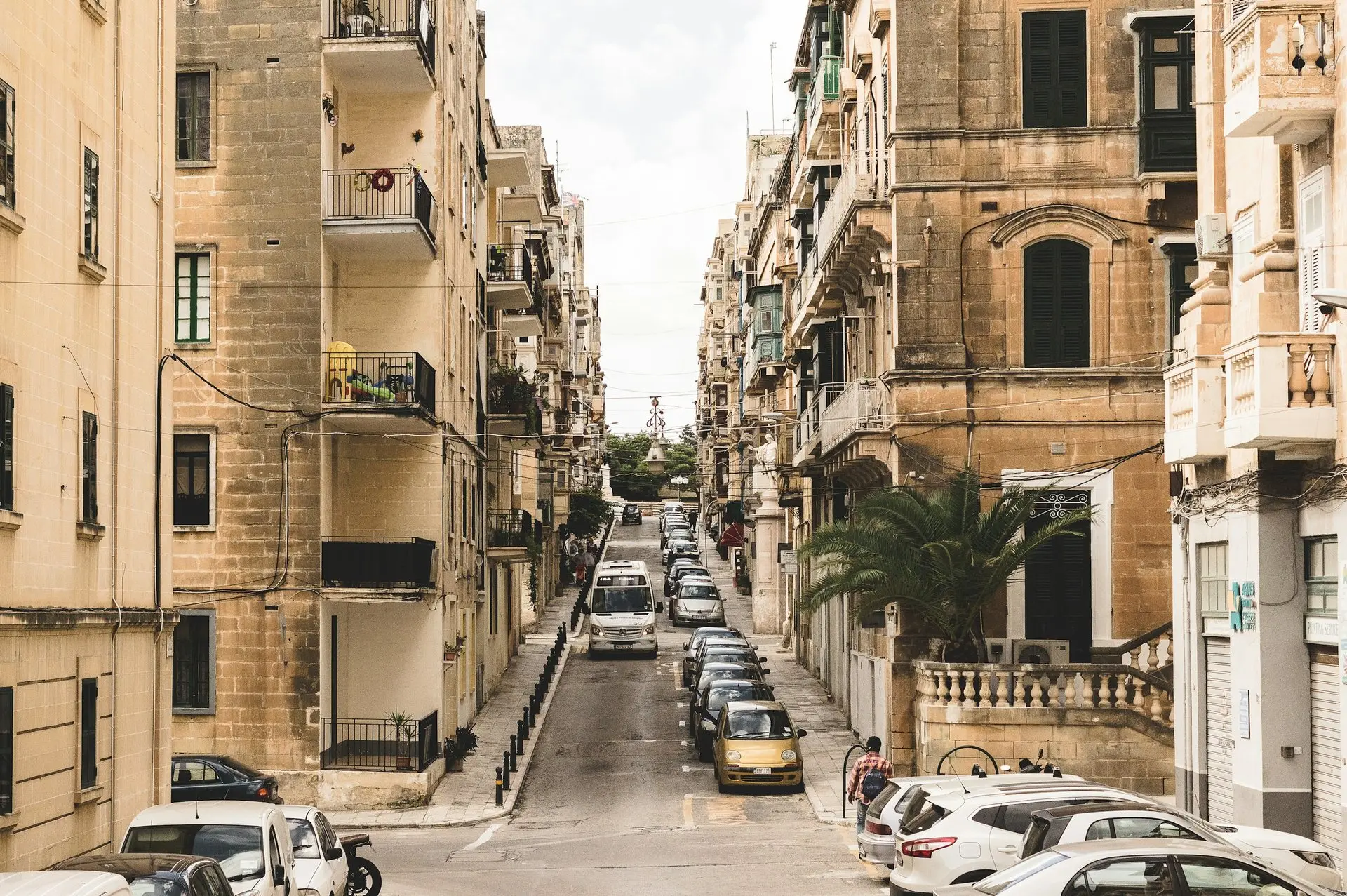 Wohnstraße in Valletta mit parkenden Autos und Kalksteinfassaden